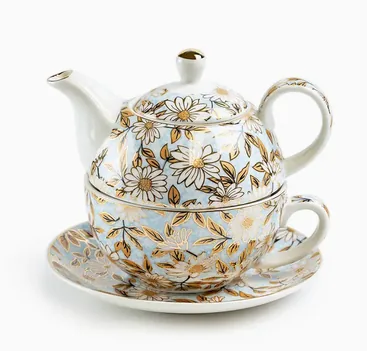 White tea-for-one set with blue and gold daisy decoration.