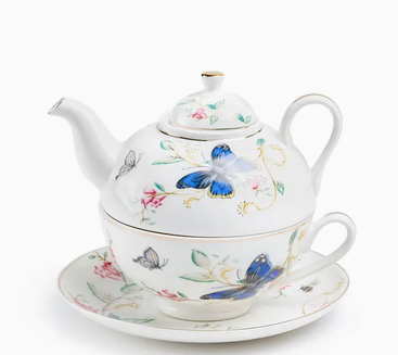 White tea-for-one set with colorful butterflies and delicate flowers.