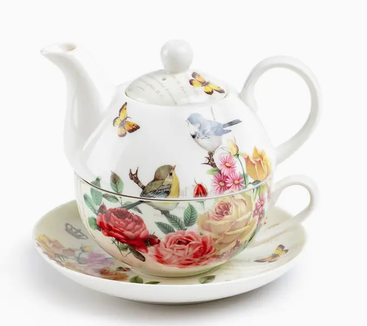 White tea-for-one set decorated with yellow and red roses and a small bird.